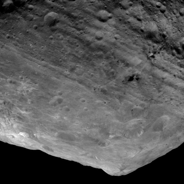 This image from NASA Dawn spacecraft is of the south pole region of the asteroid Vesta, a mountain is rising approximately 9 miles 15 kilometers above the floor of a crater.