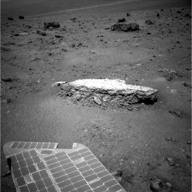 Part of NASA Mars Exploration Rover Opportunity array of photovoltaic cells is visible in the foreground of this image. Opportunity took this picture showing a light-toned rock, Tisdale