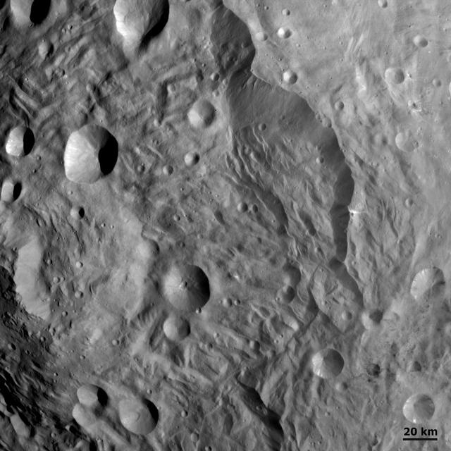Slumping features and landslides can be clearly seen near the base of the largest scarp in this image from NASA Dawn spacecraft. Some of the hummocky terrain near the scarps is probably due to landsliding.