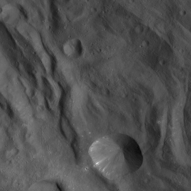 In this image of the asteroid Vesta, taken by NASA Dawn spacecraft just shortly before the beginning of high altitude mapping orbit, north is up and the upper right corner is to the northeast.