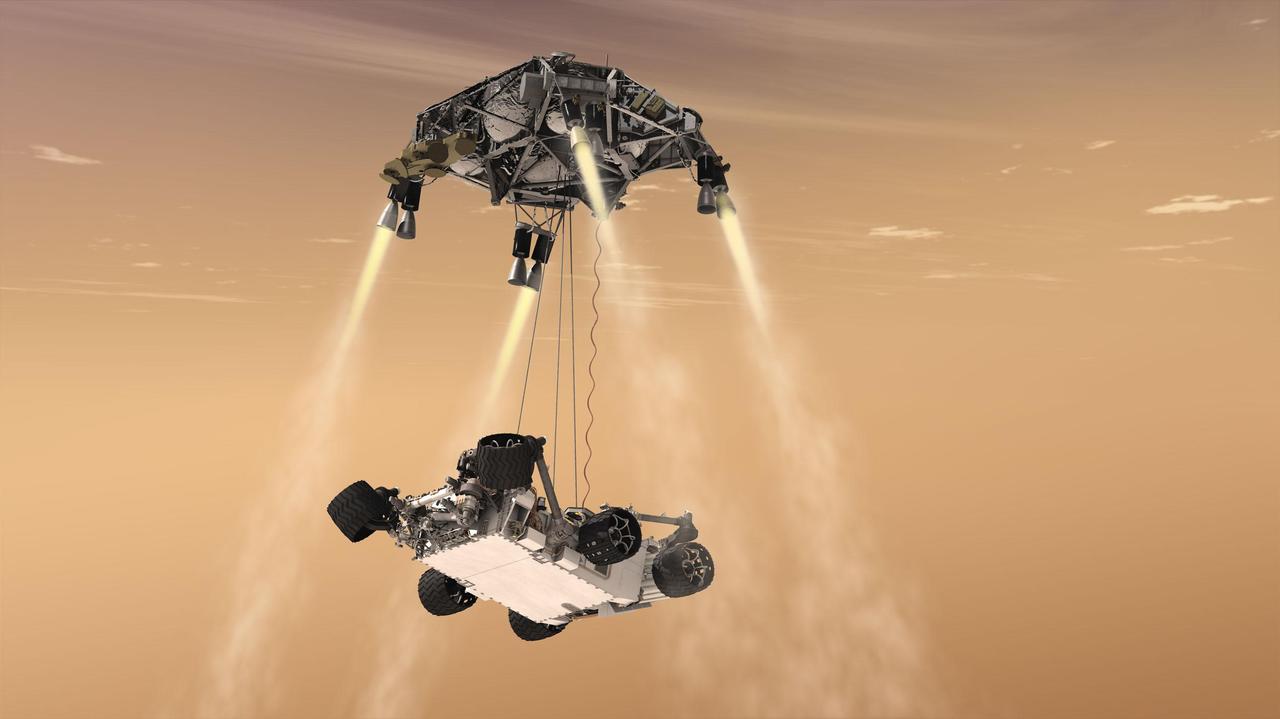 This artist concept shows the sky crane maneuver during the descent of NASA Curiosity rover to the Martian surface. The sheer size of the rover over one ton, or 900 kilograms would preclude it from taking advantage of an airbag-assisted landing.