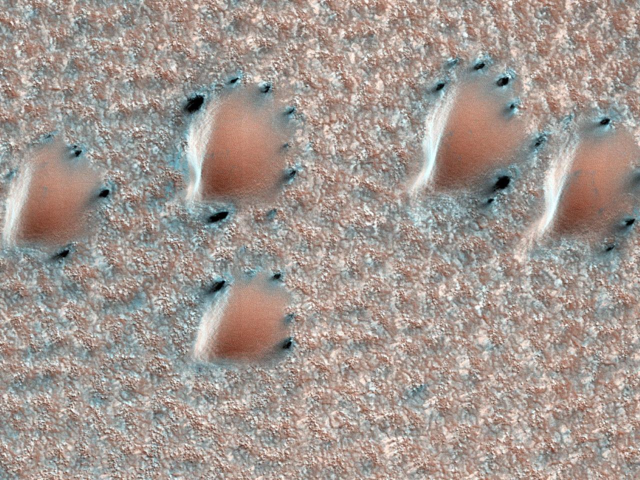 This image from NASA Mars Reconnaissance Orbiter depicts a scene from early spring in the northern hemisphere of Mars. These dunes are covered with a layer of seasonal carbon dioxide ice dry ice.