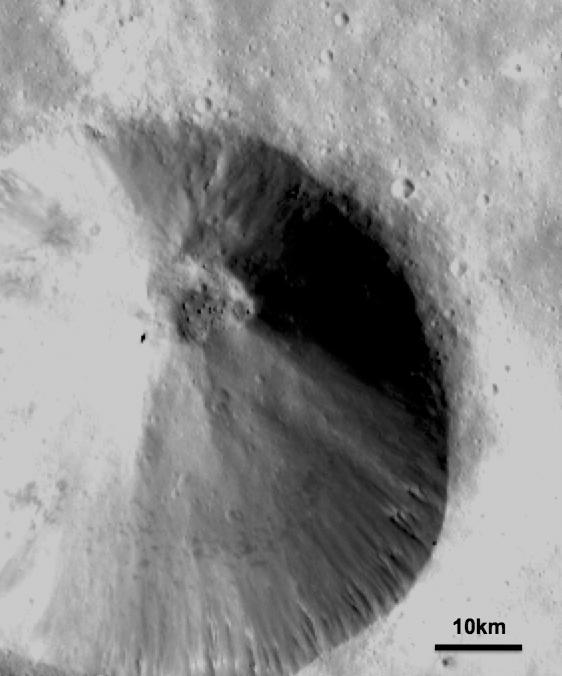 This image from NASA Dawn spacecraft shows a fresh scarp rimmed crater with many boulders on asteroid Vesta crater floor. These boulders have diameters of 100-200m, which is roughly the size of many asteroids.