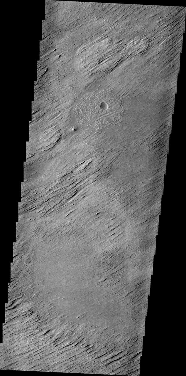 The main agent of erosion on Mars today is the wind. Wind has sculpted the surface in this region into a set of hills and valleys called yardangs on Earth. This image is from NASA 2001 Mars Odyssey spacecraft.