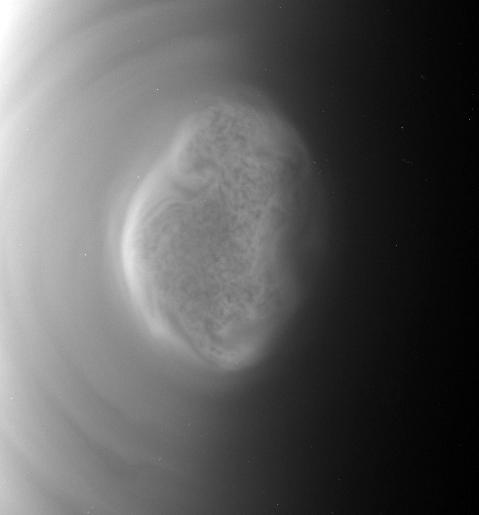 This image from a movie captured by NASAS Cassini spacecraft shows a south polar vortex, or shows a south polar vortex, or a swirling mass of gas around the pole in the atmosphere, at Saturn moon Titan.