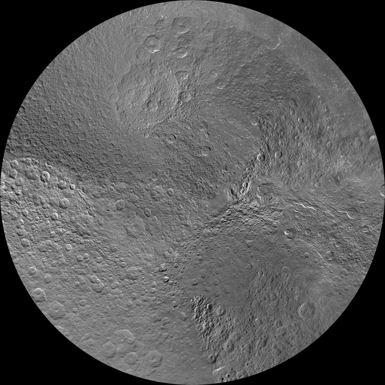 The northern and southern hemispheres of Rhea are seen in these polar stereographic maps, mosaicked from the best-available NASA Cassini and Voyager images.