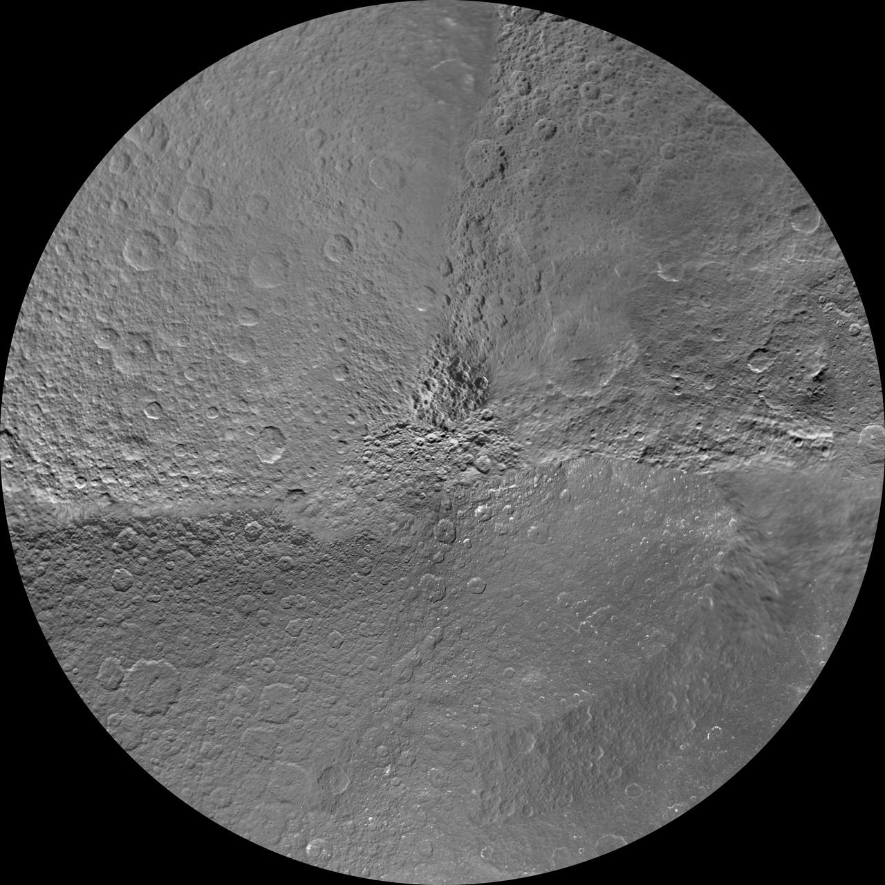 The northern and southern hemispheres of Rhea are seen in these polar stereographic maps, mosaicked from the best-available NASA Cassini and Voyager images.