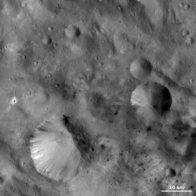 This image from NASA Dawn spacecraft shows craters with both sharp and smooth rims. The most obvious is the large crater in the bottom left of the image.