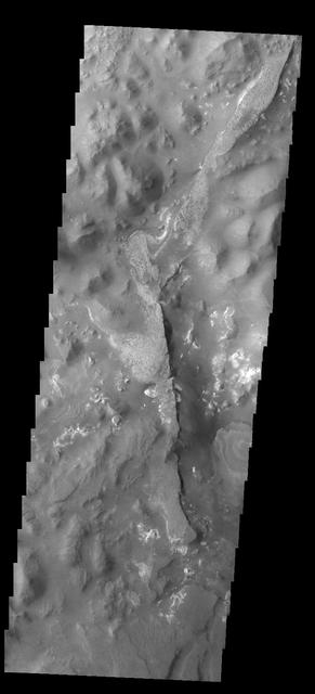 This image from NASA 2001 Mars Odyssey spacecraft shows a portion of Aureum Chaos. Several layers of material are visible in the image.