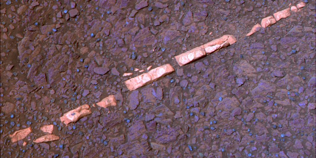 This false-color view of a mineral vein called Homestake comes from the panoramic camera Pancam on NASA Mars Exploration Rover Opportunity. The vein is about the width of a thumb and about 18 inches 45 centimeters long.