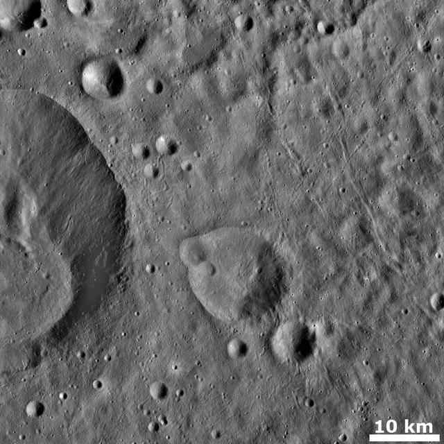 This image from NASA Dawn spacecraft shows numerous grooves linear depressions and crater chains, especially in the right hand side of the image of asteroid Vesta.