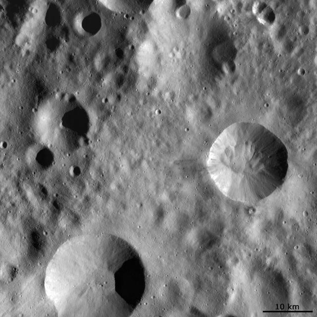 This image from NASA Dawn spacecraft shows four large impact craters close to one another on Vesta surface. Interestingly, each of these four has a distinct preservation state.