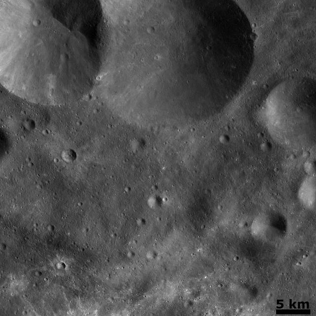 NASA image: Vesta Cratered Landscape: Double Crater and Craters with Bright Ejecta