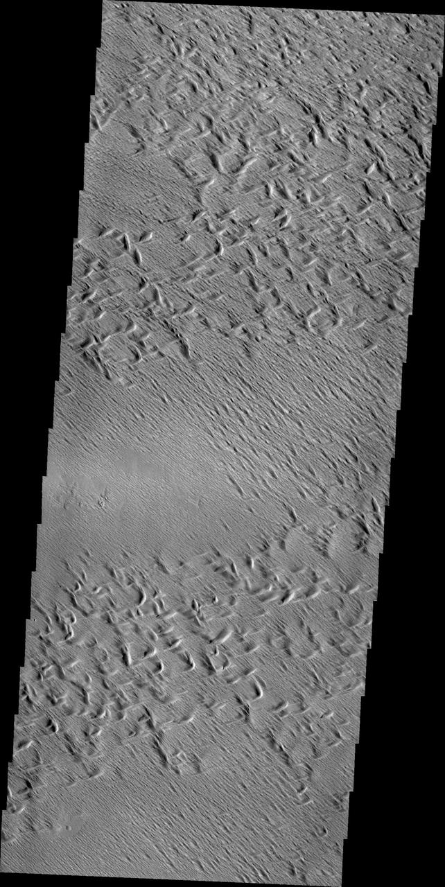 Wind erosion has created this complex surface south of Olympus Mons as seen by NASA 2001 Mars Odyssey spacecraft.
