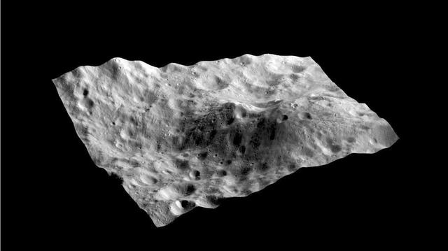 This still from a movie shows an image taken by NASA Dawn spacecraft layered on a digital terrain model of an unusual hill containing a dark-rayed impact crater and nearby dark deposit on asteroid Vesta.