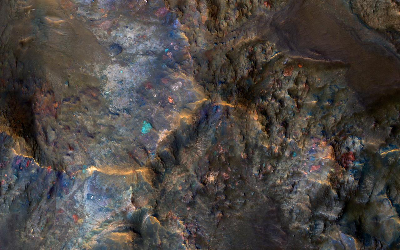 Large impact craters have central hills or mountains, because the tremendous shock waves from the impact first compresses the ground, then causes a rebound when it becomes uncompressed. This effectively raises bedrock that was once deeply buried to the surface.  Furthermore, some of the most interesting bedrock on Mars is amongst the oldest and deeply buried. Thus, these crater central uplifts act as windows into ancient Mars, and enable us to peer into a time when certain geologic processes were more active than today.  The enhanced colors in this image reflect different bedrock compositions. Some of the large blocks are broken up and jumbled by this impact event or were resampled from previous large impacts.  http://photojournal.jpl.nasa.gov/catalog/PIA15149