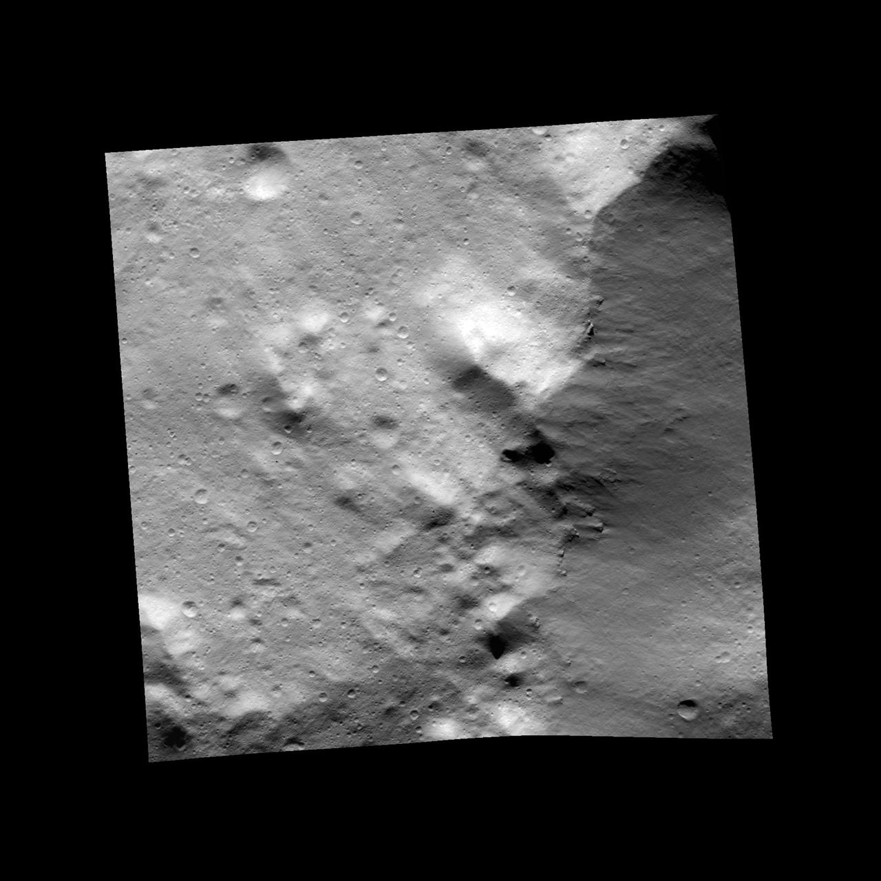 This image, one of the first obtained by NASA Dawn spacecraft in its low altitude mapping orbit, shows an area within the Rheasilvia basin in the south polar area of the giant asteroid Vesta.
