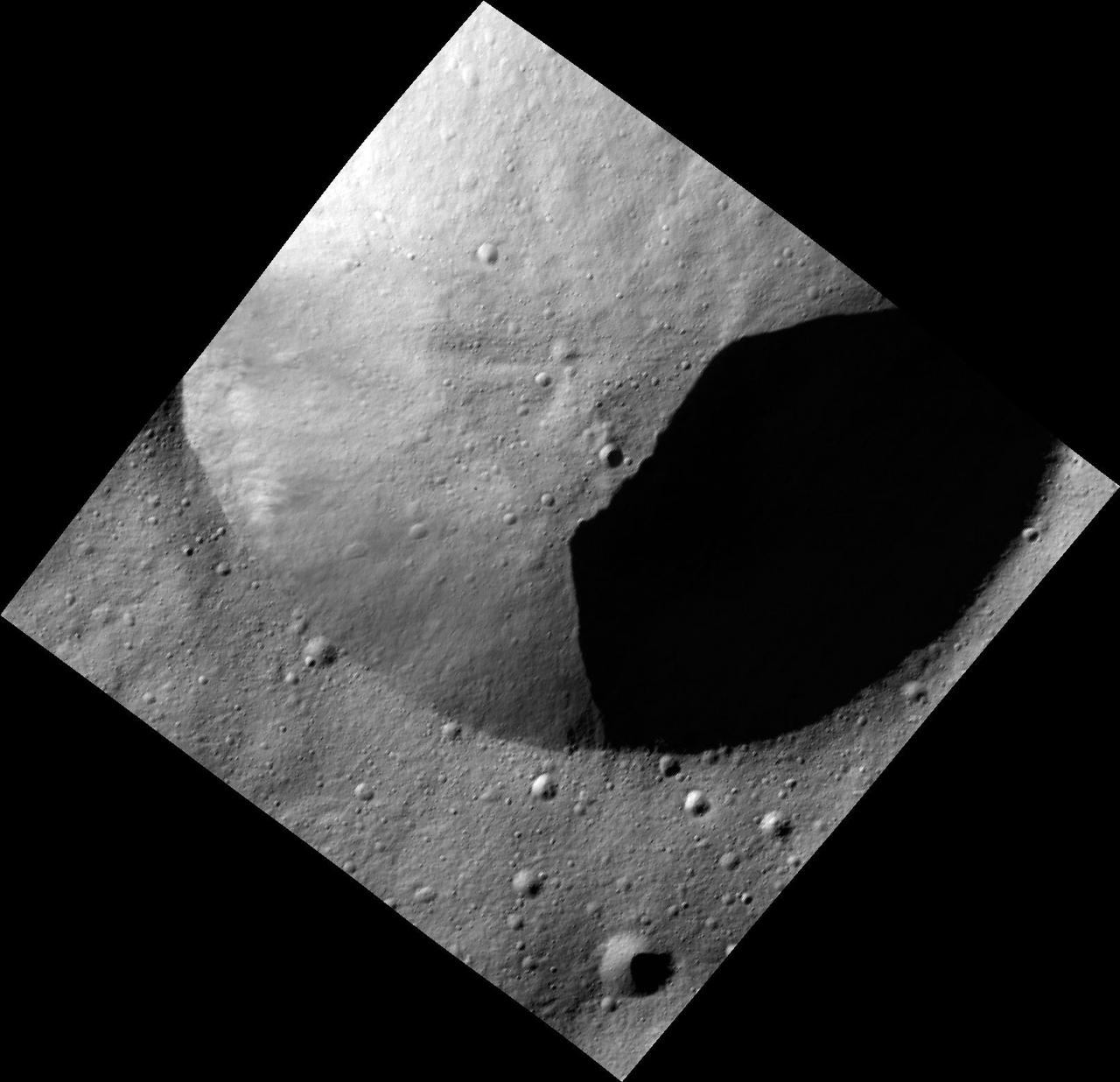 This image, one of the first obtained by NASA Dawn spacecraft in its low altitude mapping orbit, shows part of the rim of a fresh crater on the giant asteroid Vesta. The terrain is known as the Heavily Cratered Terrain in the northern hemisphere.