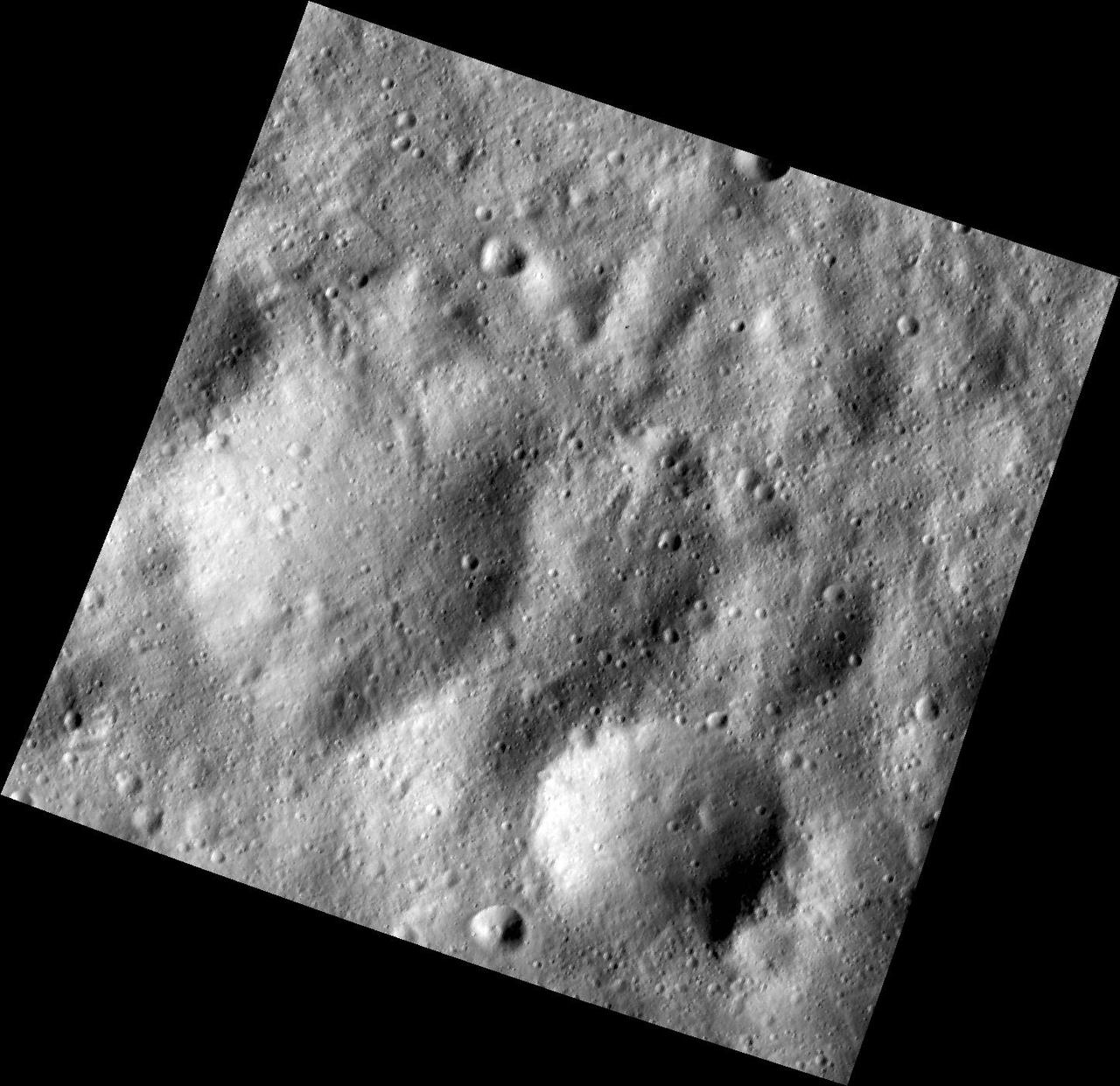 This image, one of the first obtained by NASA Dawn spacecraft in its low altitude mapping orbit, shows many buried craters located within the equatorial trough region of the giant asteroid Vesta.