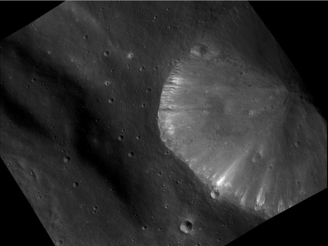 This image from NASA Dawn spacecraft shows the brightest area seen on asteroid Vesta so far. It shows a crater located inside the rim of the Rheasilvia basin at the south pole of Vesta.