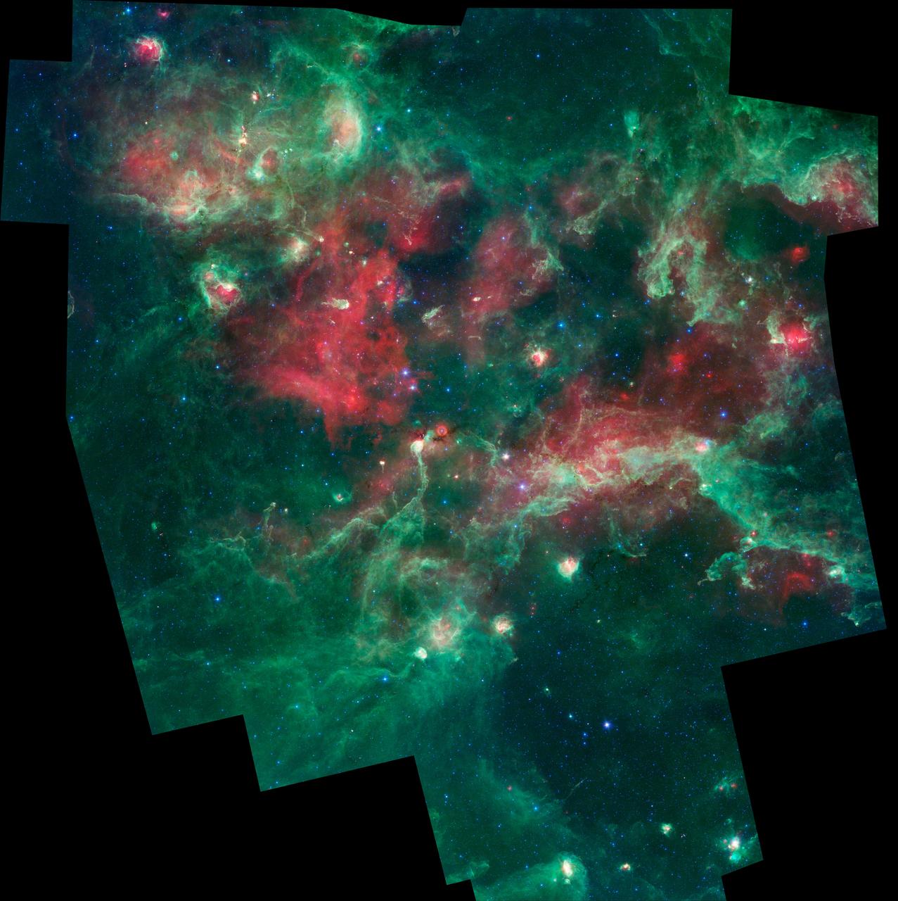 A bubbling cauldron of star birth is highlighted in this image from NASA Spitzer Space Telescope. Massive stars have blown bubbles, or cavities, in the dust and gas -- a violent process that triggers both the death and birth of stars.