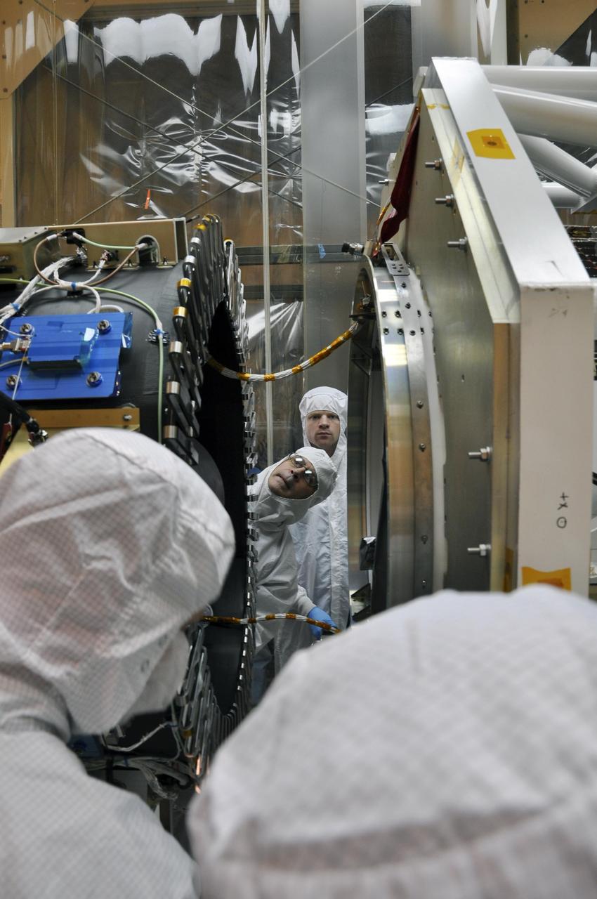 At Vandenberg Air Force Base processing facility in California, the separation ring on the aft end of NASA Nuclear Spectroscopic Telescope Array NuSTAR, at right, inches its way toward the third stage of an Orbital Sciences Pegasus XL rocket.
