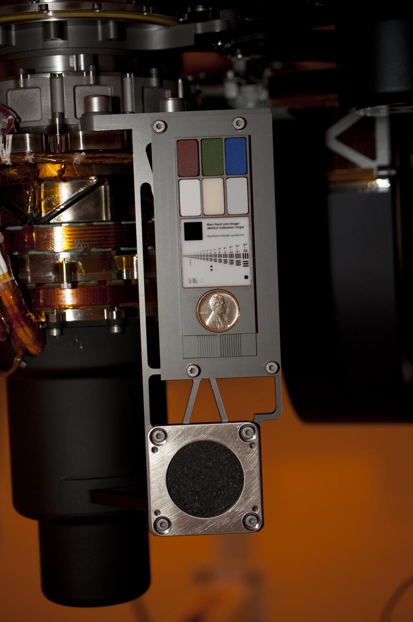 Two instruments at the end of the robotic arm on NASA Mars rover Curiosity will use calibration targets attached to a shoulder joint of the arm. The penny is a size reference giving the public a familiar object for perceiving size on Mars easily.