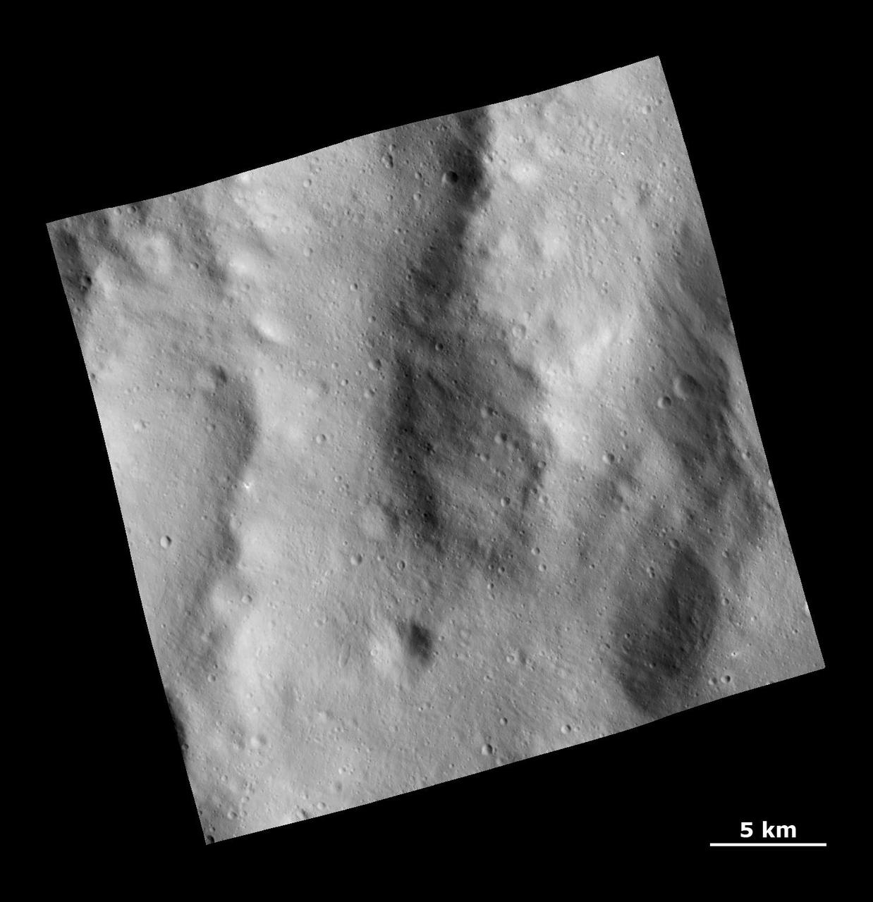 This image from NASA Dawn spacecraft shows a rough surface covered with ejecta and fine grooves on the giant asteroid Vesta.