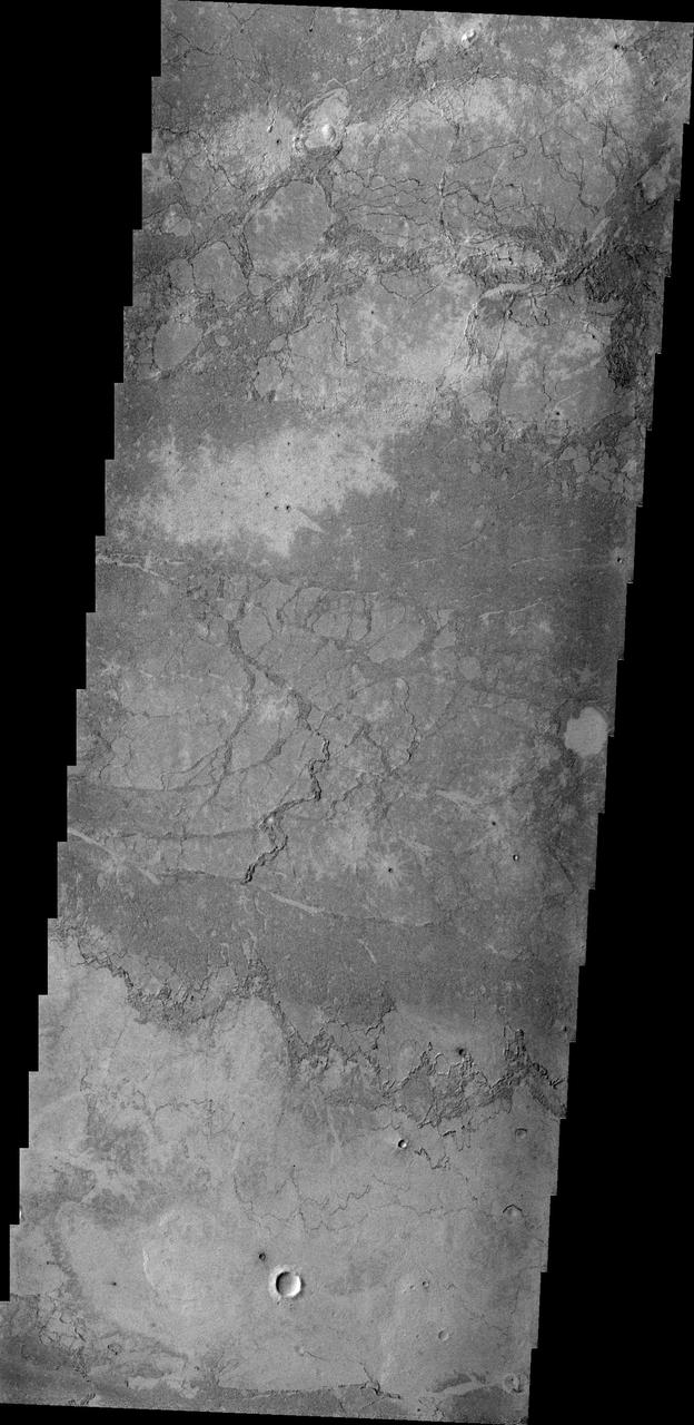 The volcanic flow in this image from NASA 2001 Mars Odyssey spacecraft appears to have flowed in one layer. The surface texture is blocks of lava which cooled and still moved on molten lava below, producing the plate-like texture.