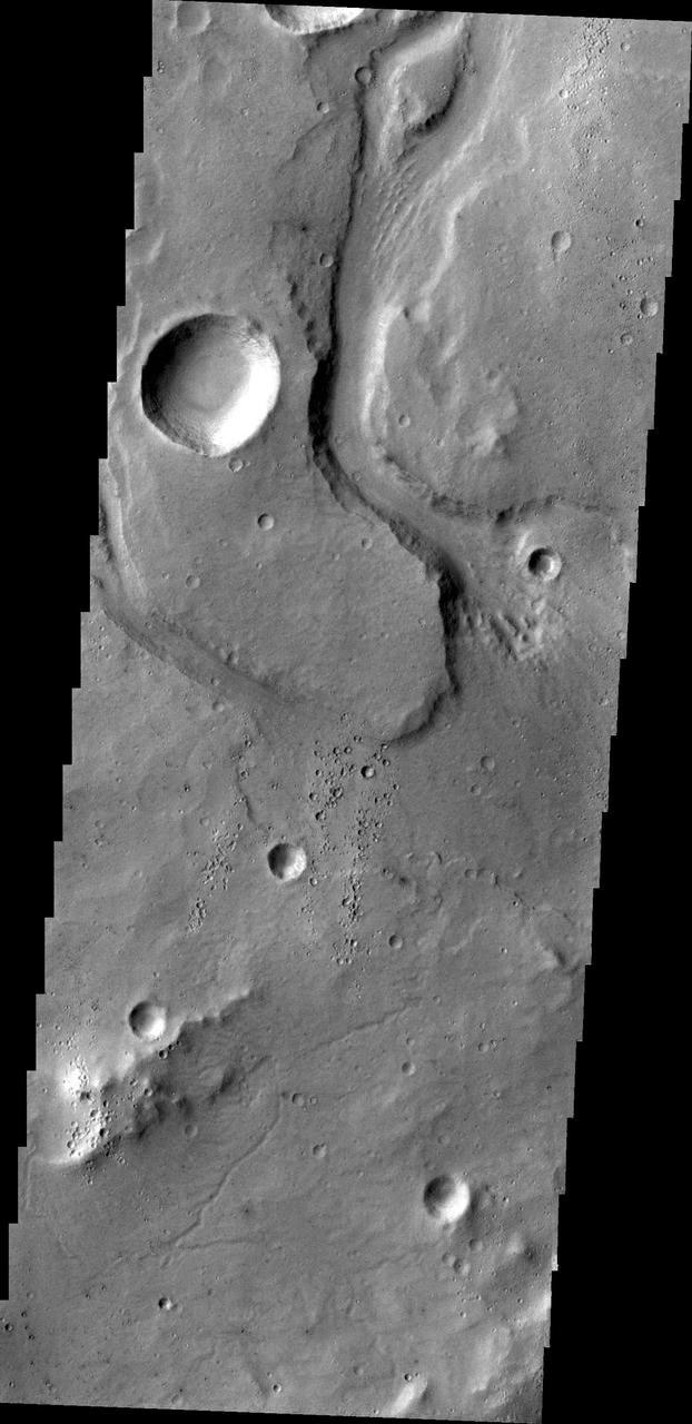 This image captured by NASA 2001 Mars Odyssey spacecraft shows an unnamed channel on part of the highlands above Tiu Valles.