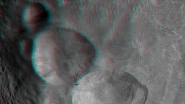 This anaglyph shows the topography of Vesta Snowman craters on asteroid Vesta. The bottom crater is named Marcia, the middle crater, Calpurnia, and the top crater, Minucia. You need 3-D glasses to view this image.