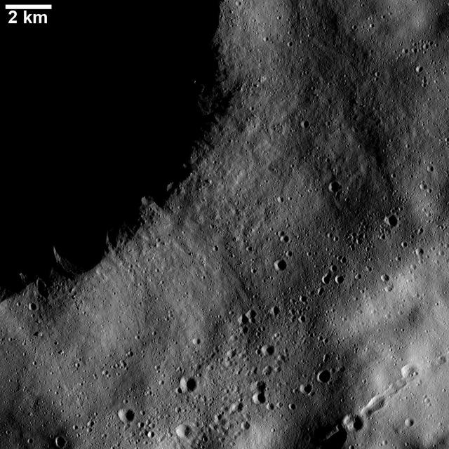 This image from NASA Dawn spacecraft shows numerous linear chains and clusters of small craters on asteroid Vesta. These chains and clusters of craters were created by material that was ejected during the formation of a large crater.