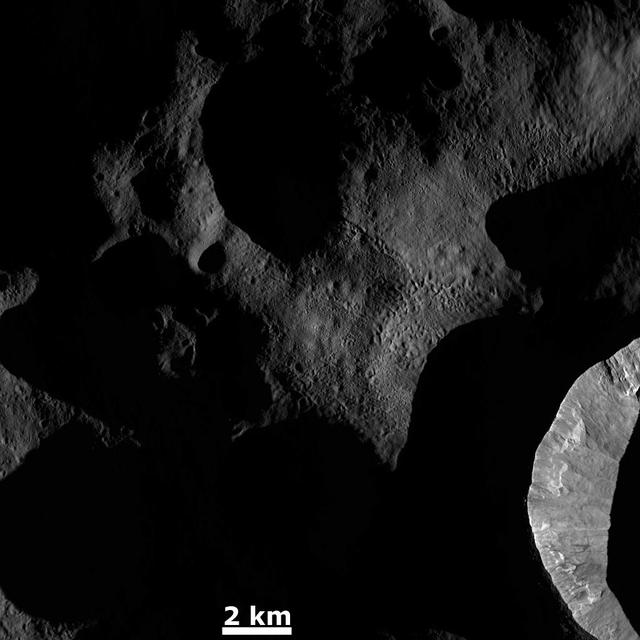 This image from NASA Dawn spacecraft shows the sun illuminating the landscape of asteroid Vesta during a Vestan unrise; the sun had a low angle relative to Vesta surface, just as the sun has a low angle in the sky in the morning on Earth.