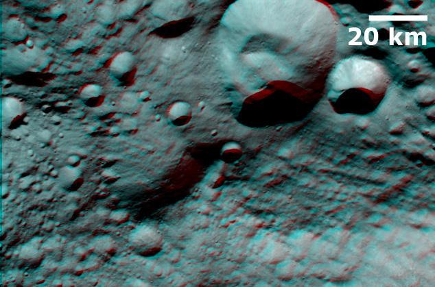 This anaglpyh from NASA Dawn spacecraft shows Caparronia crater on asteroid Vesta. The 3-D effect of the anaglyph highlights the large ridge running across the base of Caparronia crater. You will need 3-D glasses to view this image.