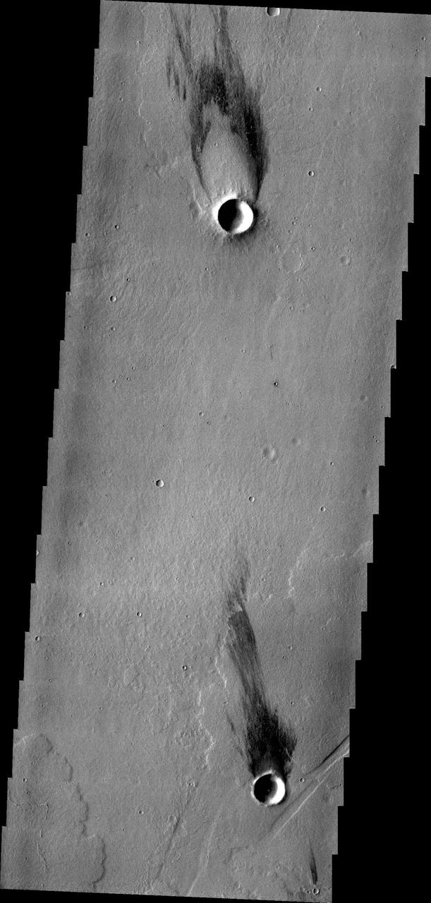 The two windstreaks in this image from NASA 2001 Mars Odyssey spacecraft are located on volcanic flows southeast of Jovis Tholus.