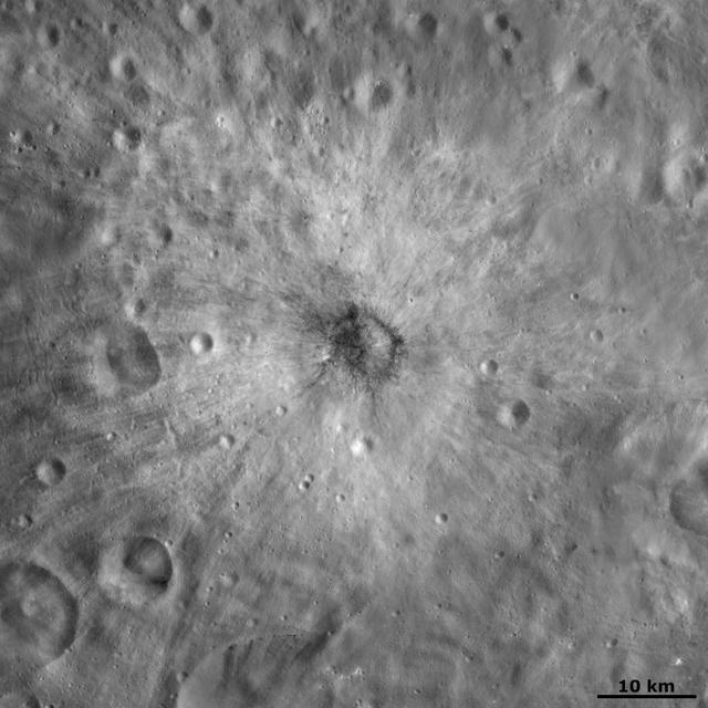 This image from NASA Dawn spacecraft is centered on asteroid Vesta Vibidia crater. There is a distinctive distribution of bright and dark material around Vibidia crater.