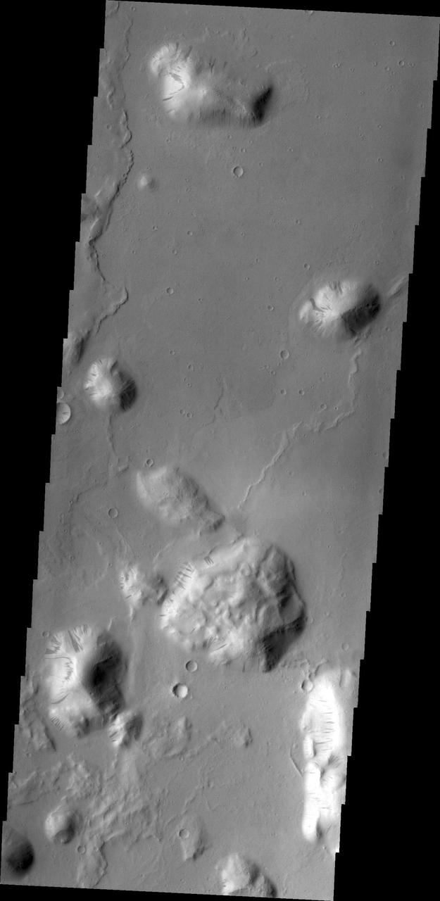 Most of the hills in this image from NASA 2001 Mars Odyssey spacecraft have dark streaks thought to be where bright dust has been removed by sliding down the hillside.