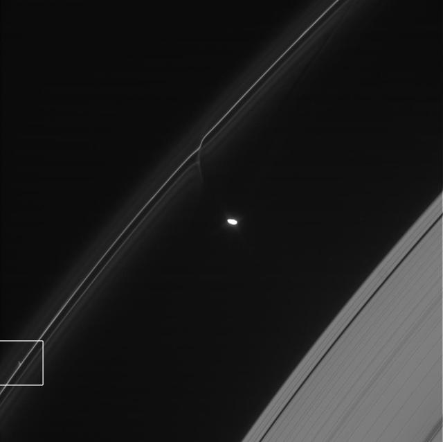 One of the glittering trails caused by small objects punching through Saturn F ring is highlighted in this image from NASA Cassini spacecraft. These trails show how the F ring, the outermost of Saturn main rings, is constantly changing.