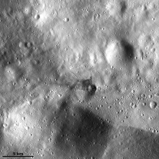 This image from NASA Dawn spacecraft, located in asteroid Vesta Urbinia quadrangle in the Vestan southern hemisphere, shows a small crater with ejecta made of dark material.