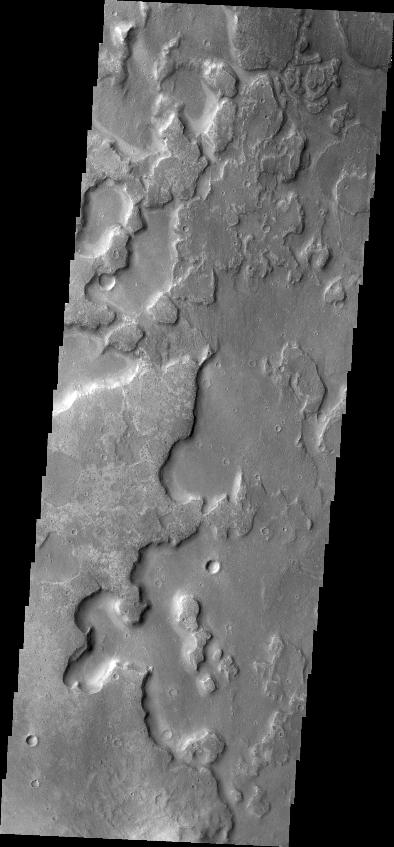 This image from NASA 2001 Mars Odyssey spacecraft shows the floor of an unnamed crater east of Aram Chaos and Ares Vallis. There are two distinct elevations on the crater floor, which may indicate layered fill material.
