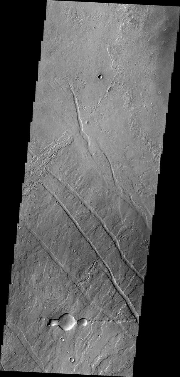 This image from NASA 2001 Mars Odyssey spacecraft of the Tharsis region illustrates relative age relations. Fractures occurred in old lava flows and then younger lava flows covered the fractures.