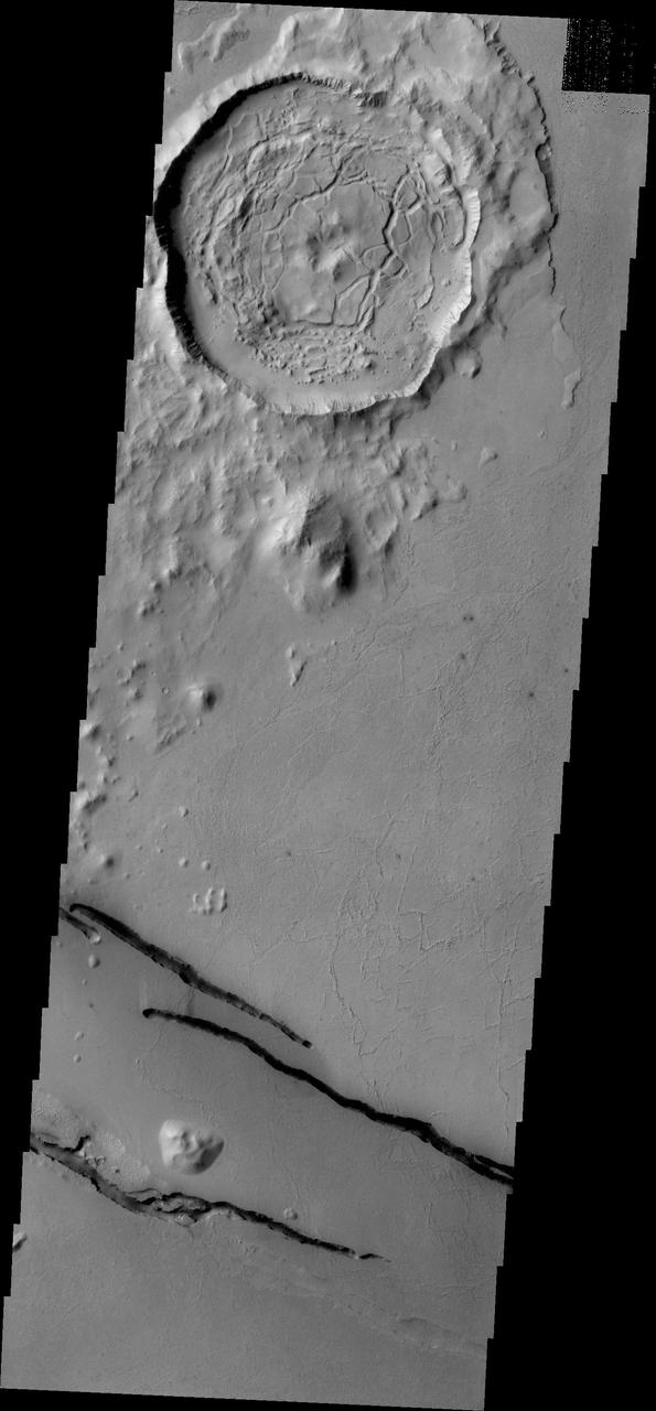 The dark fractures in this image from NASA 2001 Mars Odyssey spacecraft are part of Cerberus Fossae.