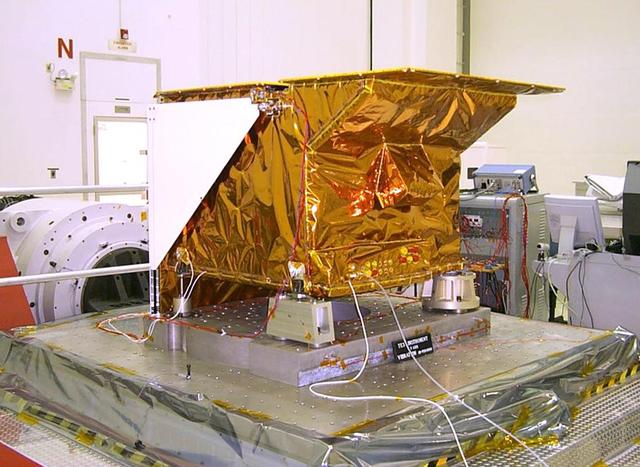 Technicians install NASA's Tropospheric Emission Spectrometer (TES) instrument on NASA's Aura spacecraft prior to launch. Launched in July 2004 and designed to fly for two years, the TES mission is currently in an extended operations phase.  Mission managers at NASA's Jet Propulsion Laboratory, Pasadena, California, are evaluating an alternate way to collect and process science data from the Tropospheric Emission Spectrometer (TES) instrument on NASA's Aura spacecraft following the age-related failure of a critical instrument component. TES is an infrared sensor designed to study Earth's troposphere, the lowermost layer of Earth's atmosphere, which is where we live. The remainder of the TES instrument, and the Aura spacecraft itself, are operating as expected, and TES continues to collect science data. TES is one of four instruments on Aura, three of which are still operating.  http://photojournal.jpl.nasa.gov/catalog/PIA15608