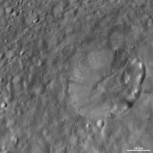 This image from NASA Dawn spacecraft of asteroid Vesta shows Octavia crater, located in Vesta Marcia quadrangle, just south of Vesta equator. Octavia rim is fresher on the right side and more degraded on the left side.