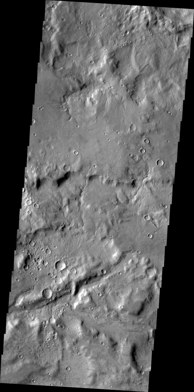 Small channels dissect the inner rim of this unnamed crater in Arabia Terra as seen by NASA 2001 Mars Odyssey spacecraft.