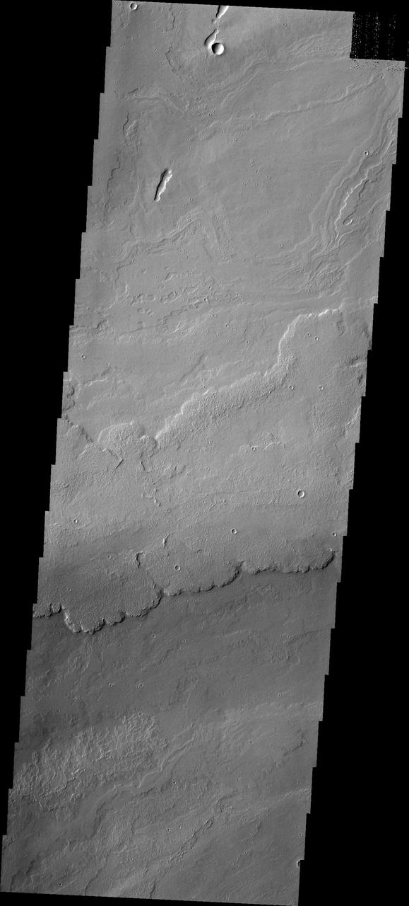 The volcanic flows in image from NASA 2001 Mars Odyssey spacecraft are located south of Ascraeus Mons and east of Pavonis Mons.
