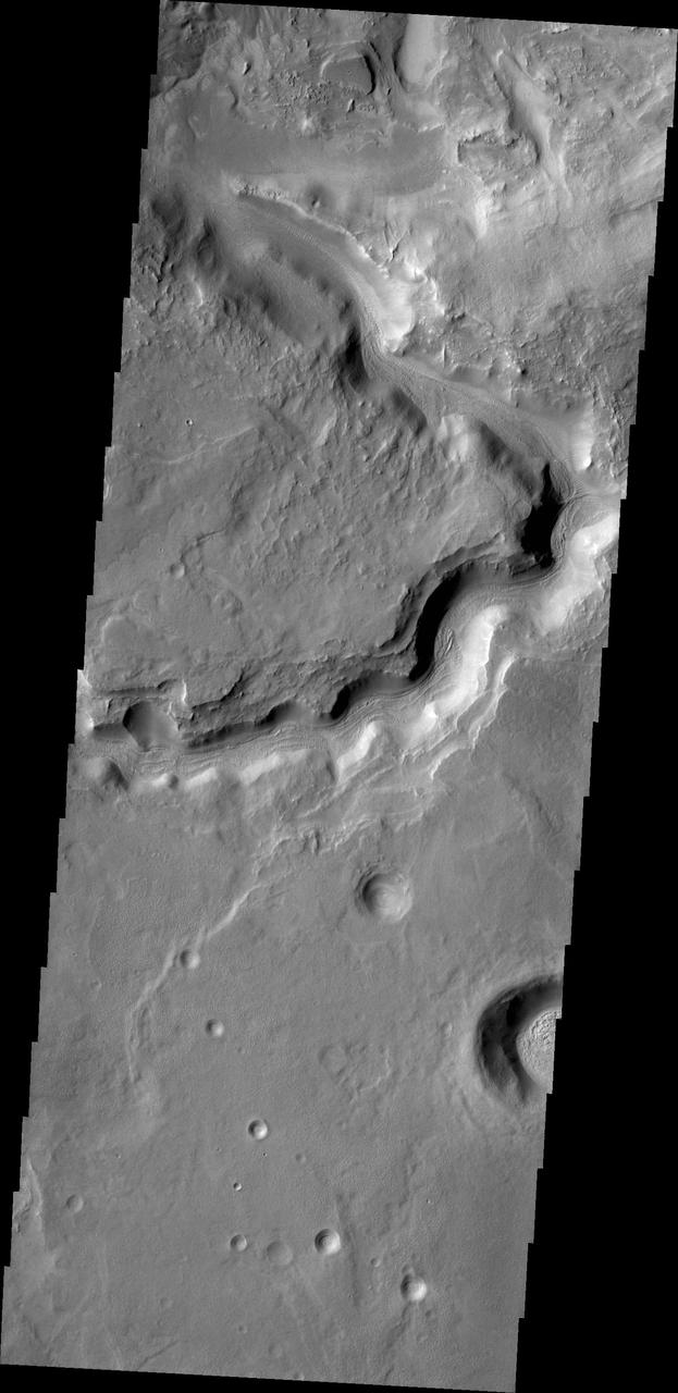 The channel in this image from NASA 2001 Mars Odyssey spacecraft is located in northern Terra Sabaea and runs semi-parallel to Auqakuh Vallis.