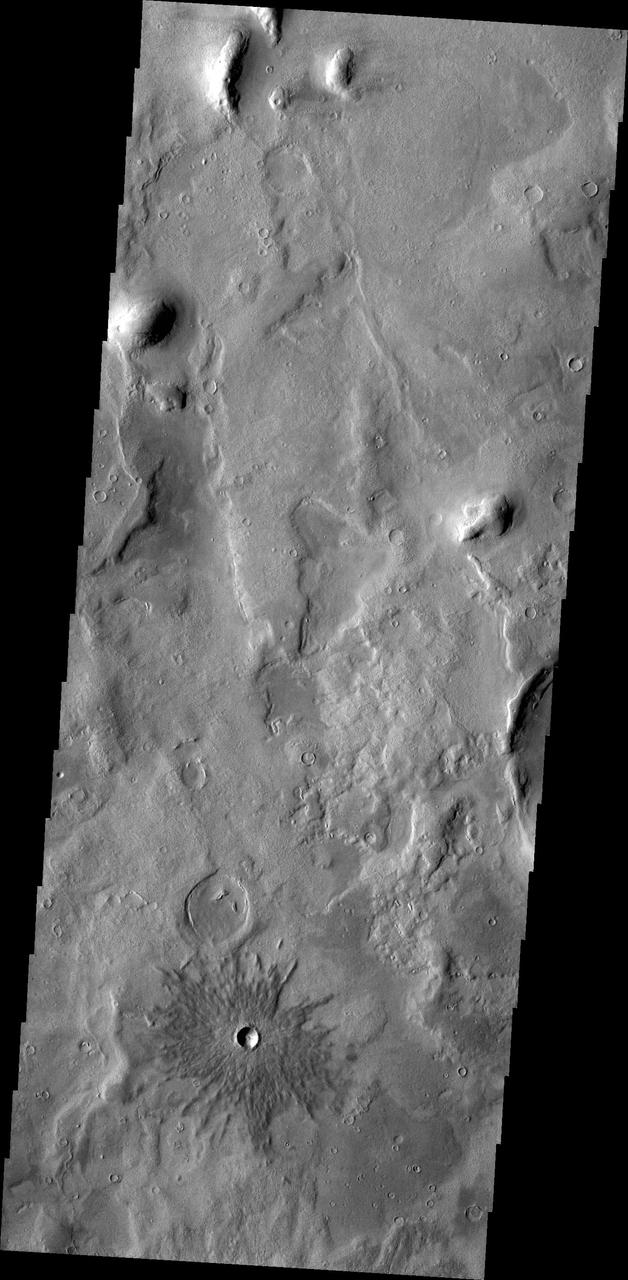This image from NASA 2001 Mars Odyssey spacecraft shows a small crater near Phlegra Montes.