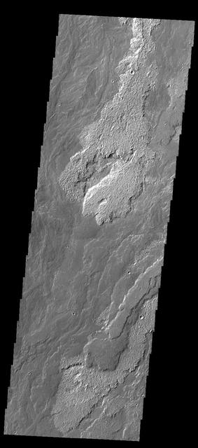 Daedalia Planum is comprised of enormous amounts of lava flows, the majority of which appear to be related to Arsia Mons. In this image from NASA 2001 Mars Odyssey spacecraft, multiple overlapping flows are evident.