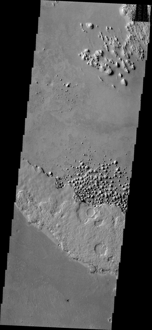 This small region of hills appears to be forming from the fractured material just south of it. This material is the northern extension of Zephyria Planum. This image is from NASA 2001 Mars Odyssey spacecraft.